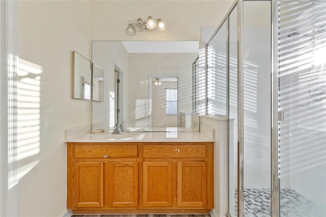 bathroom featuring vanity and an enclosed shower