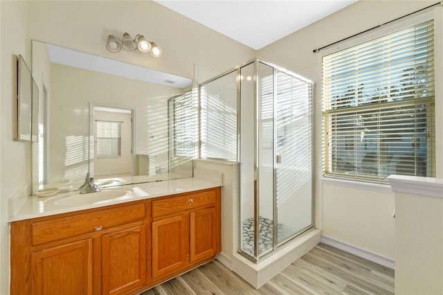 bathroom with vanity, wood-type flooring, and walk in shower