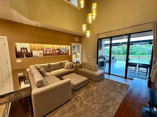 living room with wood-type flooring and a high ceiling