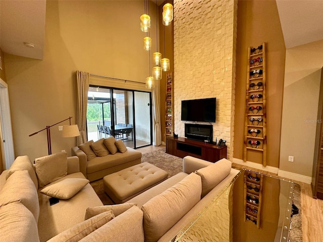 living room featuring high vaulted ceiling and light hardwood / wood-style flooring