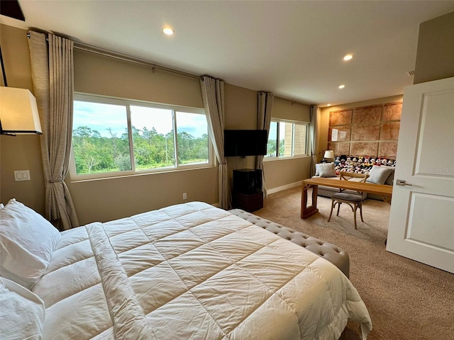 carpeted bedroom featuring multiple windows