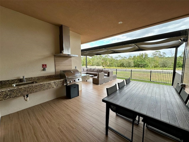 deck with an outdoor living space, grilling area, and sink