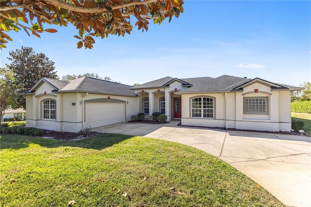 ranch-style home with a garage and a front yard