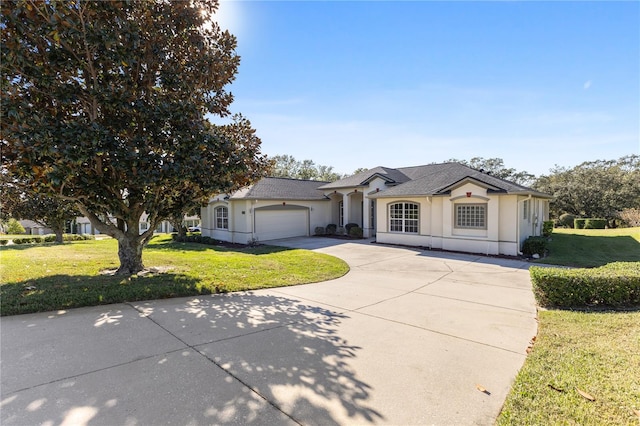 single story home with a garage and a front lawn