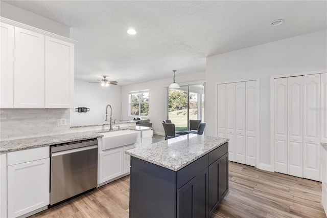 kitchen with white cabinets, dishwasher, ceiling fan, and light hardwood / wood-style flooring