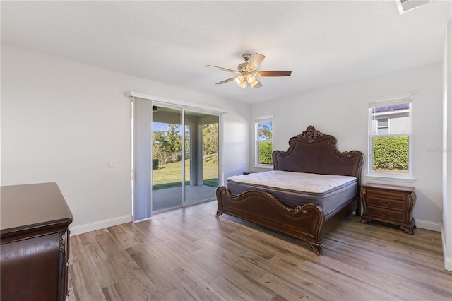 bedroom with ceiling fan, light hardwood / wood-style flooring, access to outside, and multiple windows