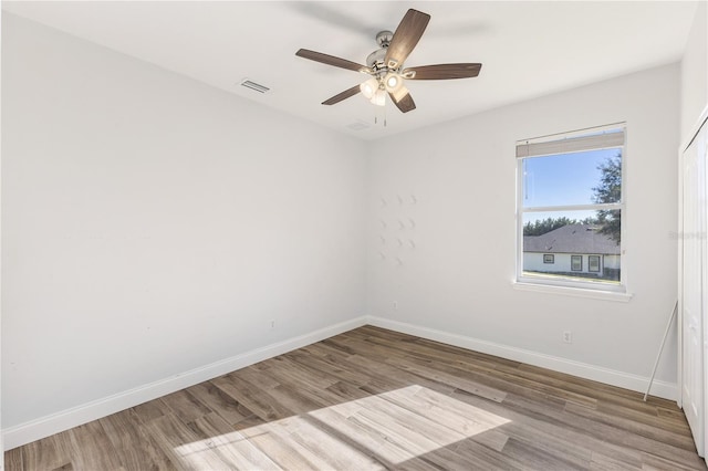 spare room featuring hardwood / wood-style flooring and ceiling fan