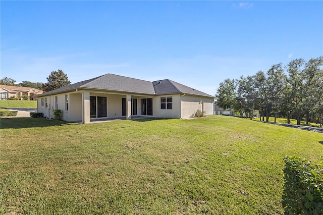 back of property featuring a lawn