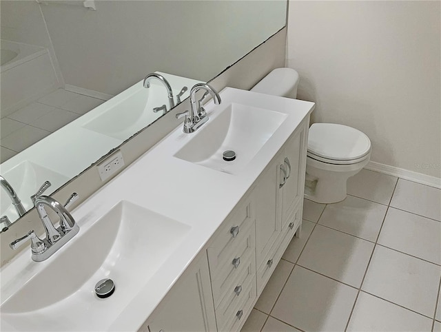 bathroom with tile patterned flooring, vanity, and toilet