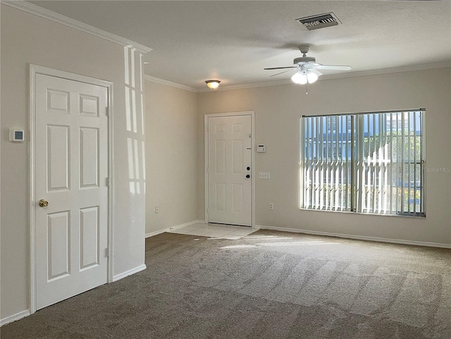 carpeted foyer entrance featuring a textured ceiling, ceiling fan, and ornamental molding