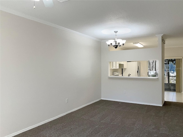 carpeted empty room with a chandelier and ornamental molding