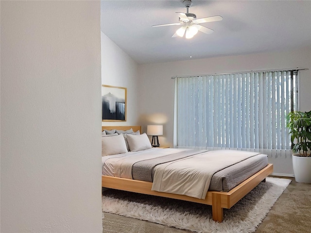 bedroom with carpet flooring, ceiling fan, and lofted ceiling