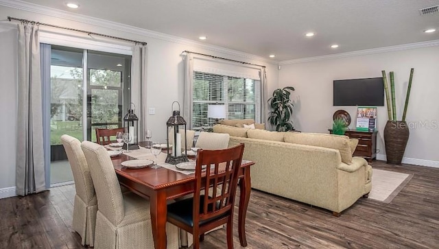 dining space with dark hardwood / wood-style floors, a healthy amount of sunlight, and crown molding