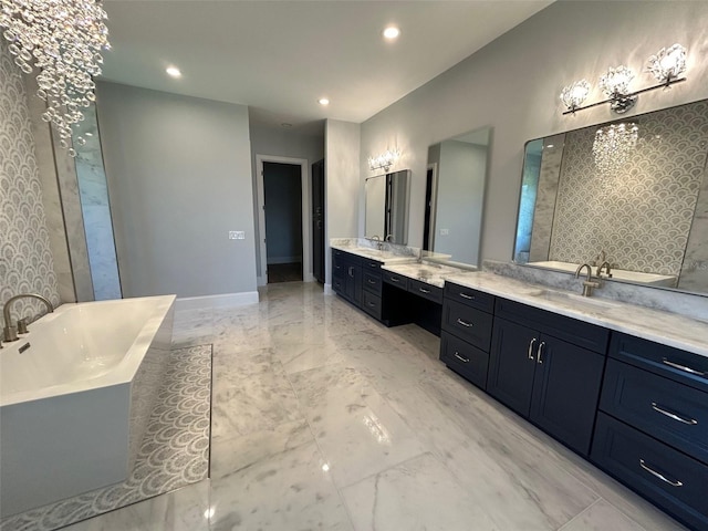 bathroom with a bathtub, vanity, and a notable chandelier