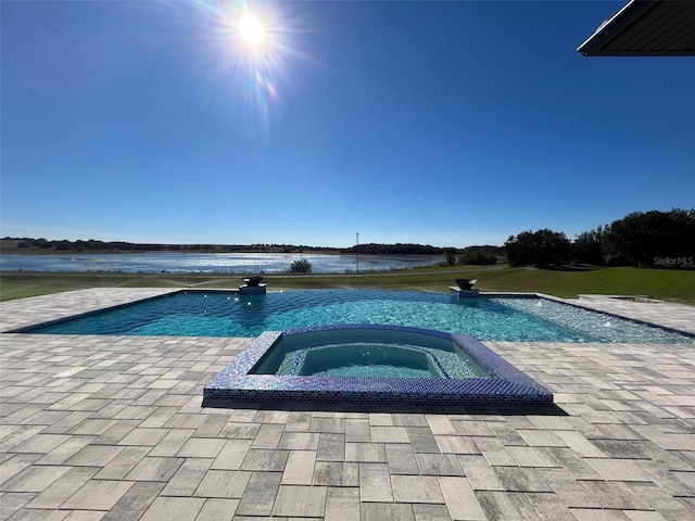 view of pool featuring a water view and an in ground hot tub