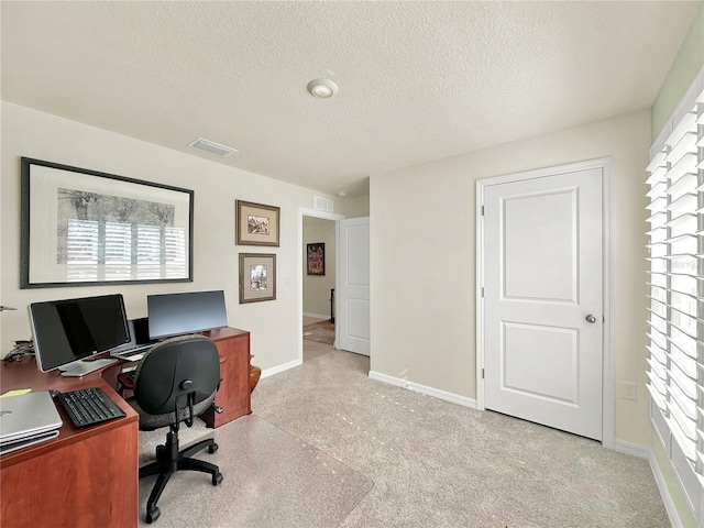 office area with a textured ceiling