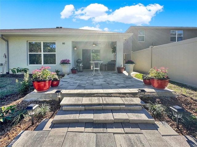 rear view of property with a patio and ceiling fan