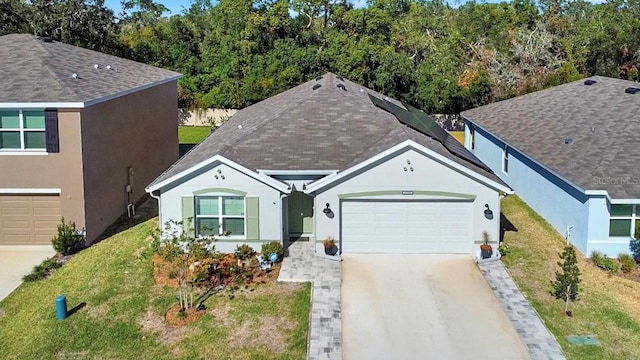 view of front of property with a front yard and a garage