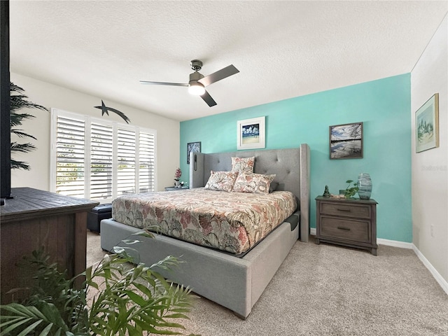 bedroom with a textured ceiling and ceiling fan