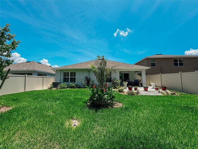 7729 Rosewood Garden Loop, Tampa, FL 33637 - rear view of property with stucco siding, a patio area, and a fenced backyard