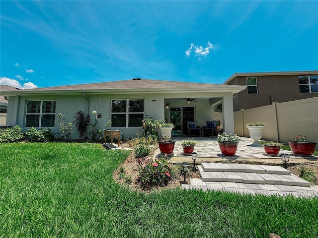 7729 Rosewood Garden Loop, Tampa, FL 33637 - back of property featuring ceiling fan, stucco siding, and a patio area