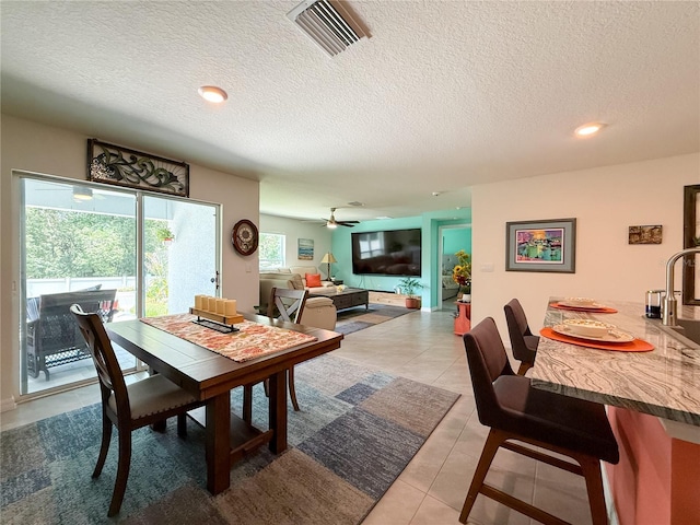 7729 Rosewood Garden Loop, Tampa, FL 33637 - dining space featuring a textured ceiling, light tile patterned floors, recessed lighting, and a ceiling fan