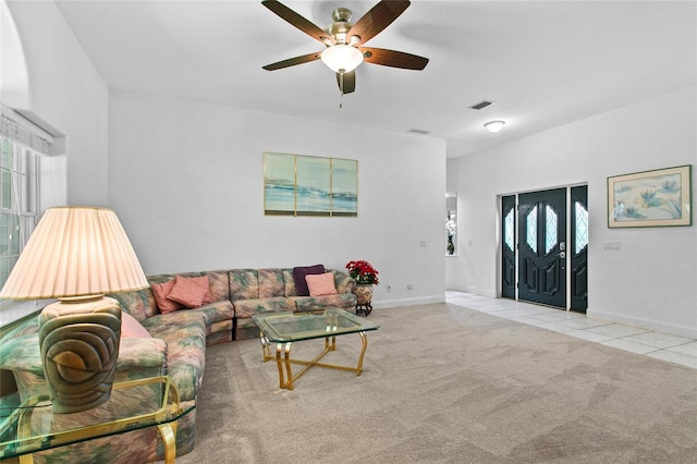 tiled living room with ceiling fan