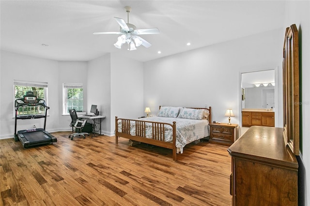 bedroom featuring ensuite bath, light hardwood / wood-style flooring, and ceiling fan