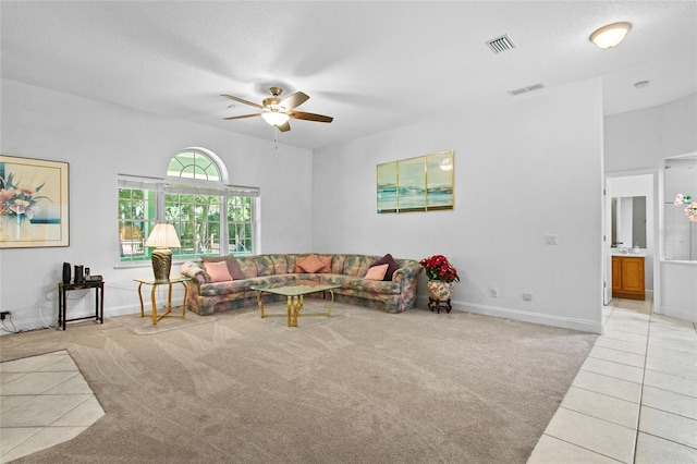 tiled living room featuring ceiling fan and a textured ceiling