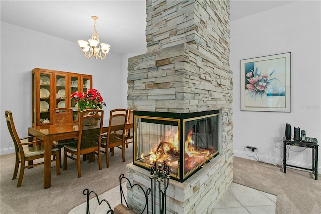 carpeted dining space featuring a stone fireplace and a notable chandelier