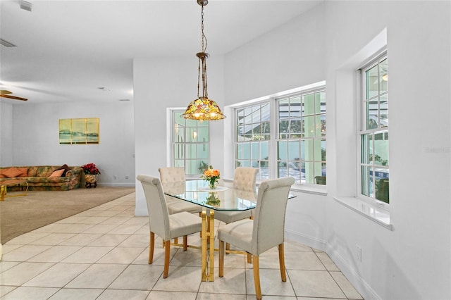 dining space featuring light carpet, ceiling fan, and lofted ceiling