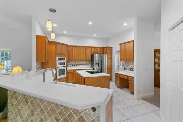 kitchen featuring white double oven, stainless steel refrigerator with ice dispenser, backsplash, kitchen peninsula, and decorative light fixtures