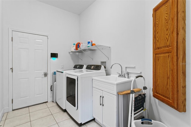 laundry room with cabinets, separate washer and dryer, and light tile patterned flooring