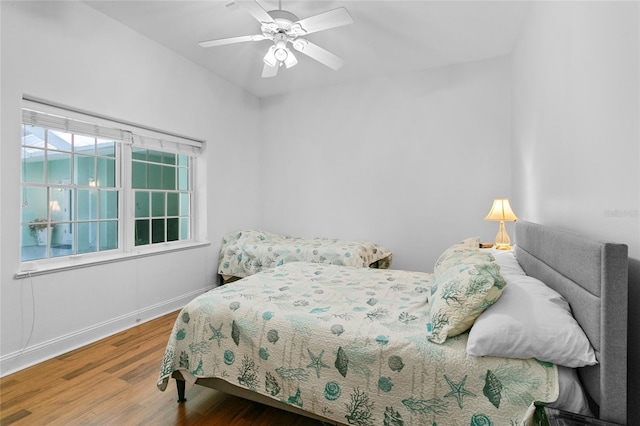 bedroom with hardwood / wood-style floors and ceiling fan