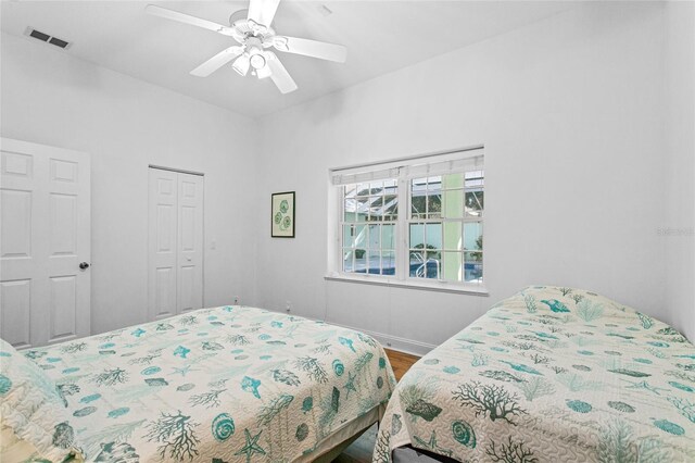 bedroom featuring wood-type flooring, a closet, and ceiling fan