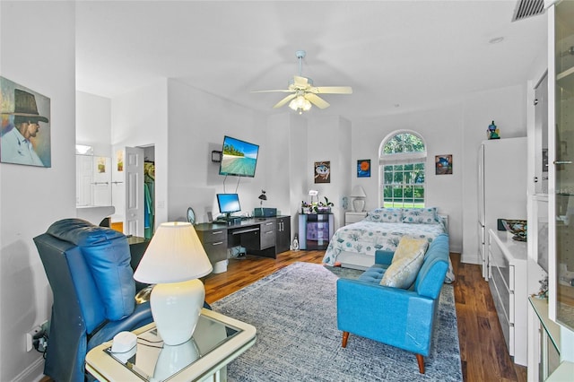 living room featuring ceiling fan and dark hardwood / wood-style floors