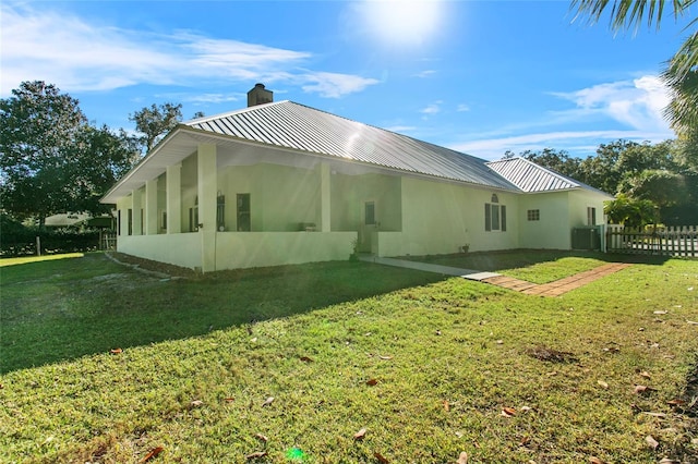 view of home's exterior with a yard and central AC