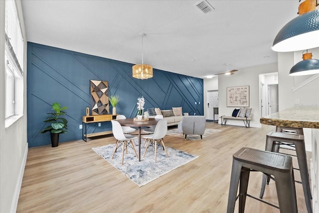 dining room featuring a notable chandelier and light wood-type flooring