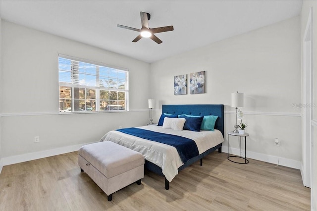 bedroom with ceiling fan and light hardwood / wood-style floors