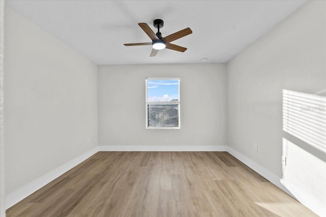 spare room featuring light hardwood / wood-style flooring and ceiling fan