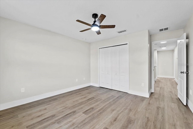 unfurnished bedroom with ceiling fan, a closet, and light hardwood / wood-style floors