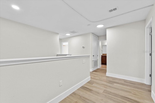 corridor with light hardwood / wood-style flooring