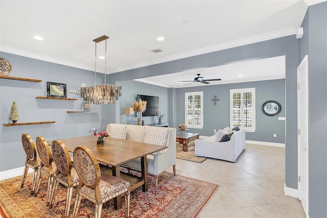 dining area featuring ceiling fan, light tile patterned flooring, and crown molding