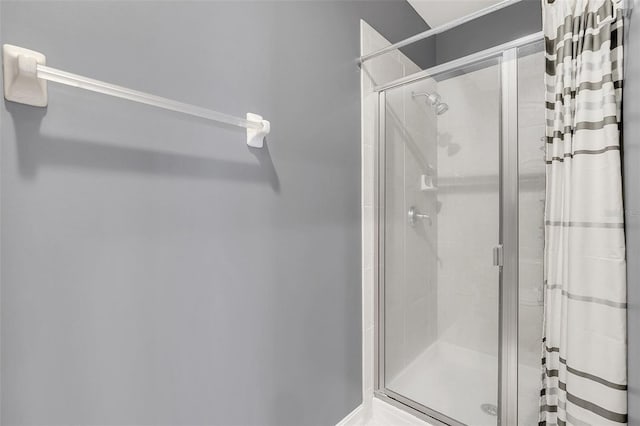 bathroom featuring a shower with shower door