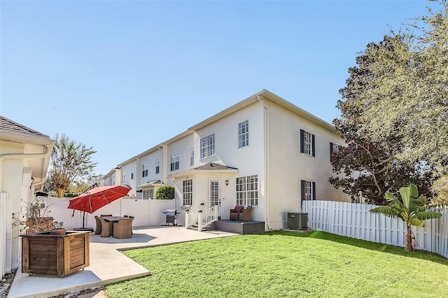 back of property with cooling unit, a patio, and a lawn