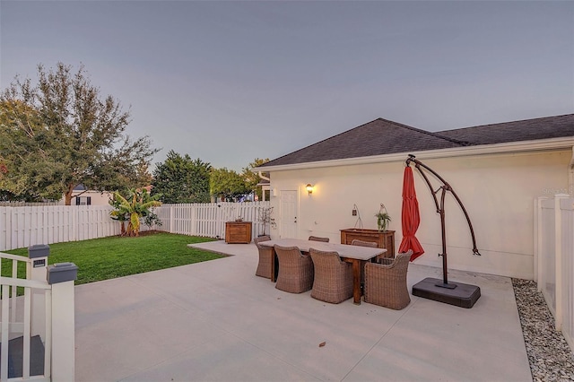 patio terrace at dusk with a lawn