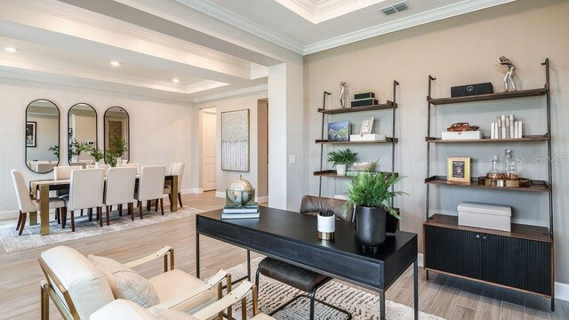 home office with light hardwood / wood-style floors and ornamental molding