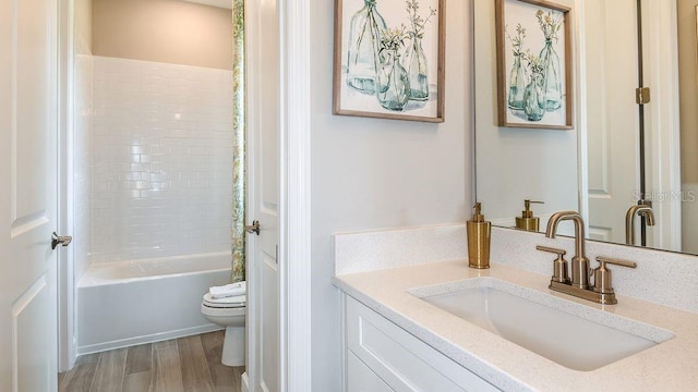 full bathroom with vanity, toilet, wood-type flooring, and bathtub / shower combination