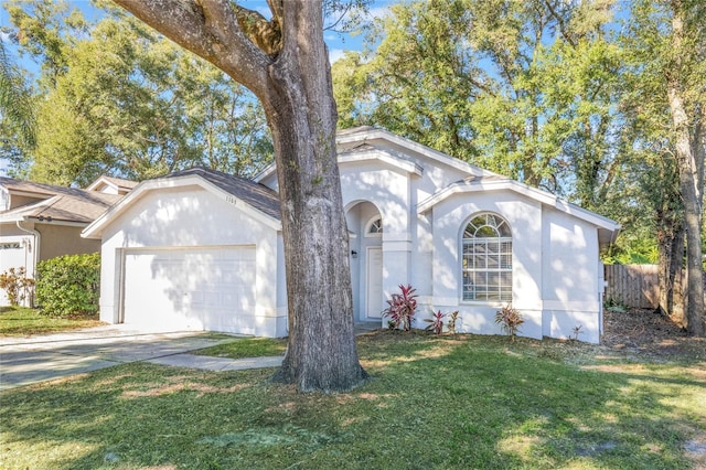 single story home featuring a front yard and a garage