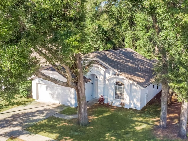 view of front facade with a front lawn and a garage